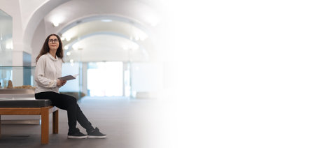 Web banner of educational excursion. Young woman sitting on bench in museum. light hall background. Mock up and copy space. Concept of cultural exhibition and education.の写真素材