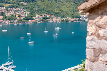 Panoramic view from above of bay with boats. Summer holidays at Mediterranean resort. View from the paved stone wall.の写真素材