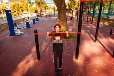 Top view of adult pretty Caucasian woman push-up in horizontal bar. Concept of sport lifestyle.