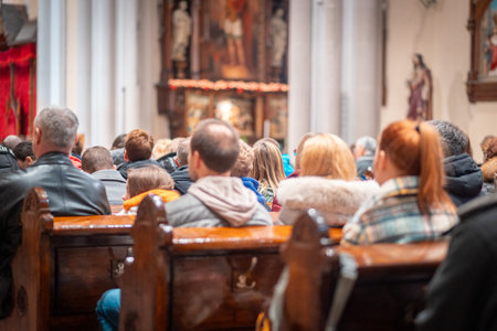 Back view of sitting parishioners. The Catholic Orthodox Christmas holiday in Europe.の写真素材