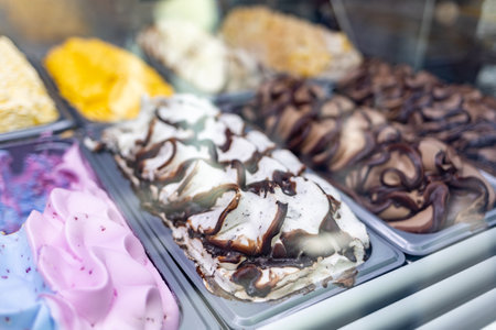 Close up of different varieties of handmade ice cream in trays in the cafe. Delicious cooling summer sweets.の写真素材