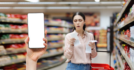 Sales in supermarket. Portrait of young Caucasian shocked woman check paper receipts. Hand shows...
