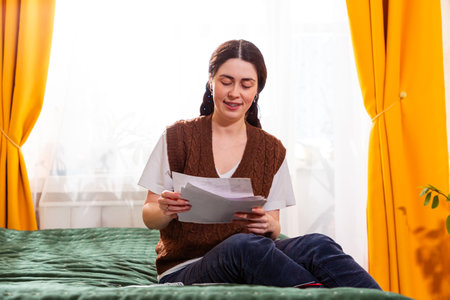 Portrait of responsible female analyzing home expenses, planning finances, and ensuring proper accounting. Economy and investment concept..の写真素材