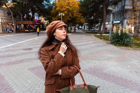 City walk on a fall weekend reveals a graceful woman deep in her emotions and thoughtsの写真素材