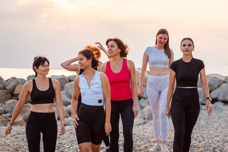 Group of different Caucasian young women walking together at the beach after training. Fitness and wellnessの写真素材