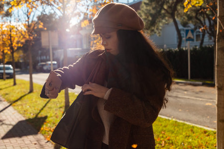A pensive mood defines the weekend walk of a young woman through the citys golden light