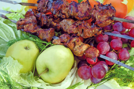 The baked meat on a background of vegetables and fruitの写真素材