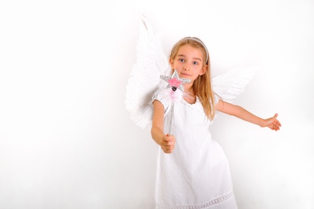 A little girl dressed as an angel with a magic wand.の写真素材