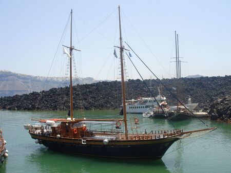 Beautiful Wood Boat near volcano of Santorini -Greeceの写真素材