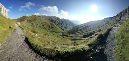 mountain scenery with rocks and clouds along the alpine trailの写真素材
