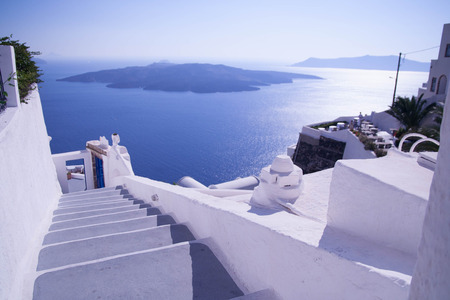 view from Santorini, Greece - sun, blue sky, sea and white stairsの写真素材