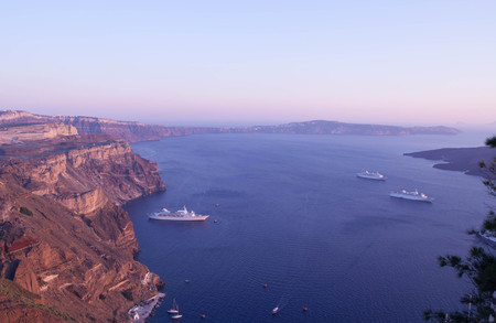 view from Santorini, Greece - sun, blue sky, sea and rocksの写真素材