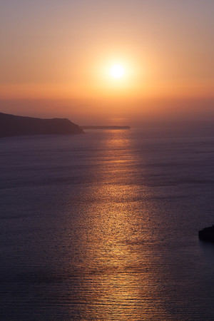 view from Santorini, Greece - sun, blue sky, sea and rocksの写真素材