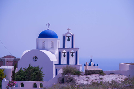 White Chapel with blue dome in Santorini, Greece - blue sky, bellsの写真素材