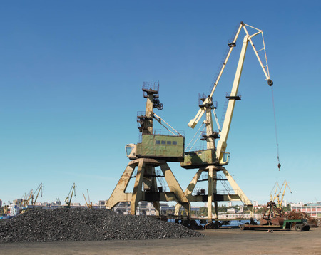 Cranes and charcoal in port with blue sky background - cargo / industry / transport / Constanta portの写真素材