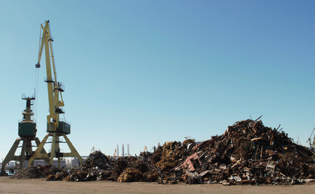 Cranes and scrap in port with blue sky background - load / industry / transport / waste / recycling / Constanta portの写真素材