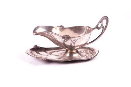 handcrafted art nouveau silver cup sauce over a white backgroundの写真素材