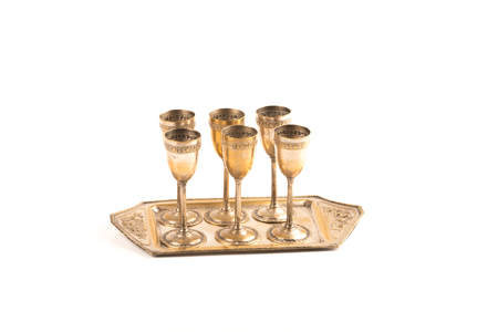 handcrafted  bronze glasses with a beverage tray over a white backgroundの写真素材