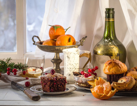 Christmas and New Year still life with tangerines, cake and wineの写真素材