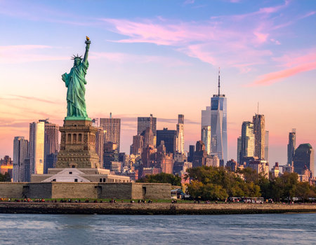 Statue of Liberty and New York City skyline at sunset, USAの写真素材