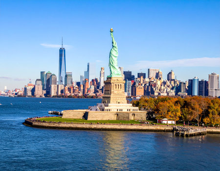 Statue of Liberty and New York City skyline at sunny day.の写真素材