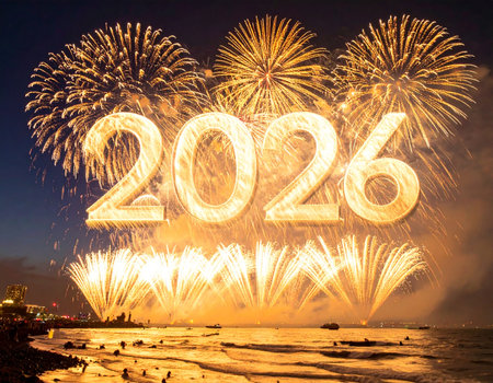 Happy new year 2026 written with Sparkle firework on beach and sea backgroundの写真素材