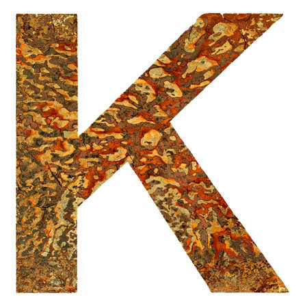 Cracked rusty coarse K letter isolated on white background.の写真素材
