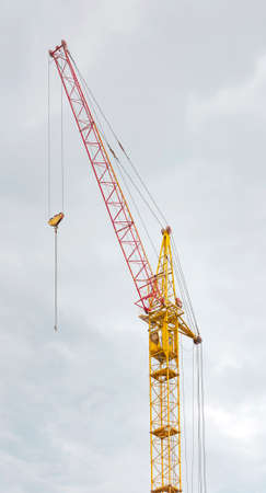 Construction crane tower against a blue sky.