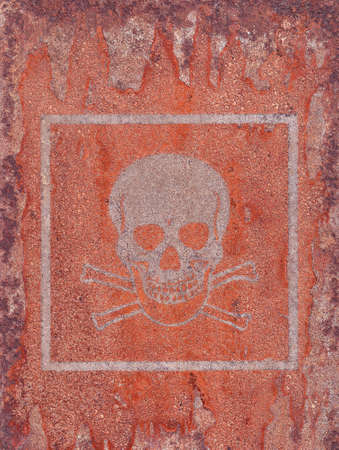 Acute toxicity.Hazard symbol.Mark from an old sticker on a rusty metal surface.の写真素材