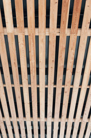 View of the ceiling upholstered with wooden slats.の写真素材