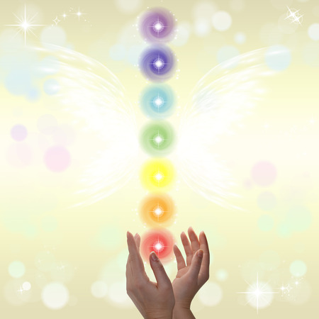 Healing Hands and seven chakras on a sparklingpastel coloured backgroundの写真素材