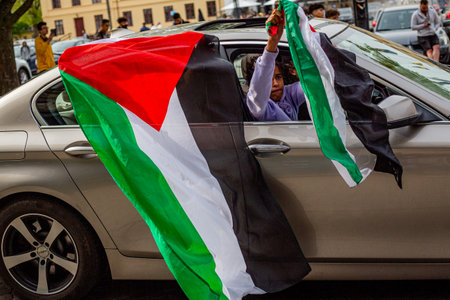 KRISTIANSTAD, SWEDEN - MAY 14, 2021: Palestine flag waved out from car during protest against Israels newly planned attacks on Gazaのeditorial素材