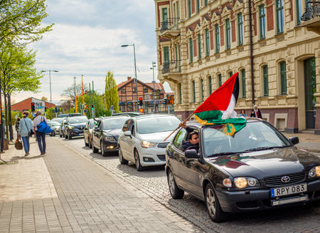 KRISTIANSTAD, SWEDEN - MAY 14, 2021: Palestine flag waved out from car during protest against Israels newly planned attacks on Gazaのeditorial素材