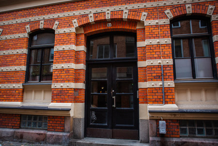 Gate in brick house with wall decorations in Malmo, Sweden