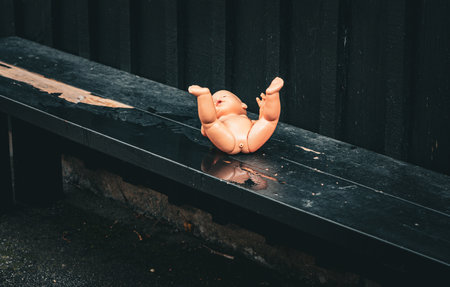 Doll left on bench with legs upの写真素材