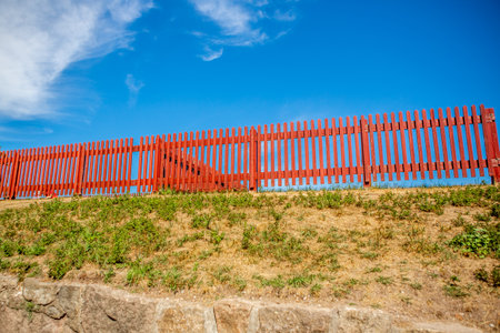Red fence and blue sky 2の写真素材