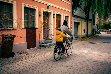 Woman rides child on bicycle in Malmo, Swedenの写真素材