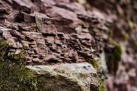 red rock wall of ravine with green moss closeup wild natureの写真素材