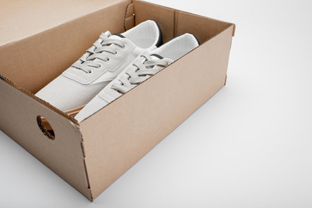 White sneakers on white background. Banner with copy space. Comfortable sports shoes. Unisex casual...