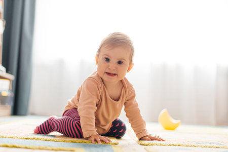 The child learns to crawl on the floor.