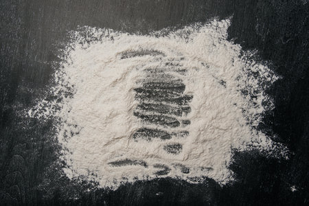 Flour scattered on a black board. Bakingの写真素材