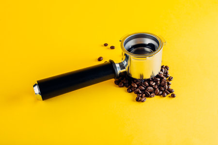 Portafilter on coffee beans. Yellow port background filterの写真素材