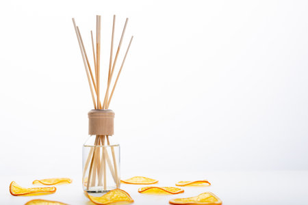 Reed diffuser and different citrus fruits on tableの写真素材