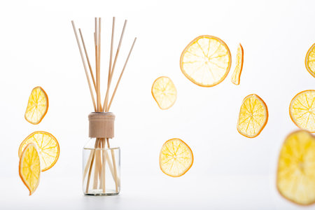 Reed diffuser and different citrus fruits on tableの写真素材