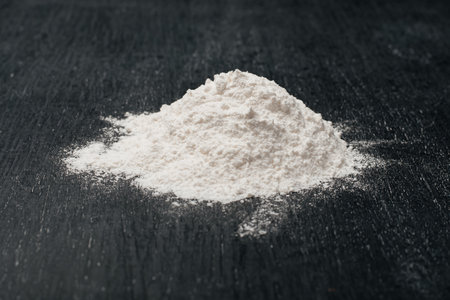 Flour on black wood background. Baking homeの写真素材