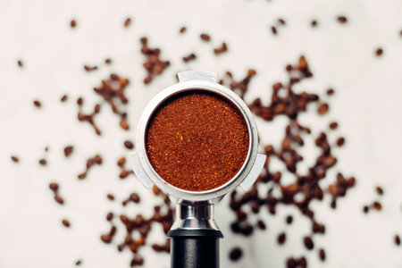 Portafilter with ground coffee on a light gray background. The view from the top.の写真素材