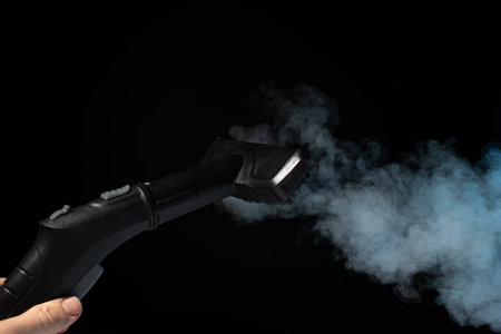 Clean steam washing concept on black background.の写真素材