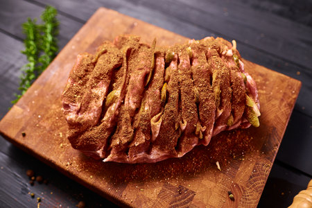 Meat with spices ready for baking in the oven. Cooking meat