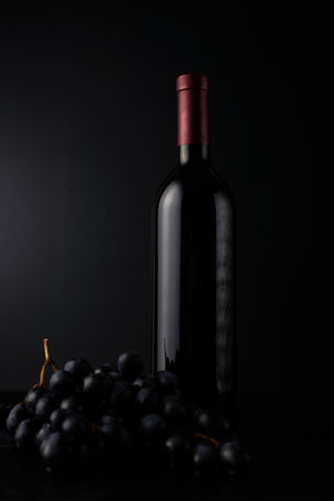 bottle of red wine on dark background.の写真素材