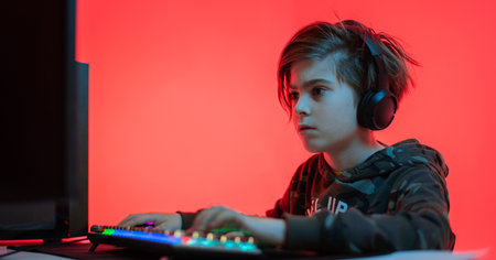 computer games, playing place, young gamer plays computer games with headphones,の写真素材